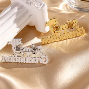 Macro detail of gold and silver graduation pins with cap design on satin cloth