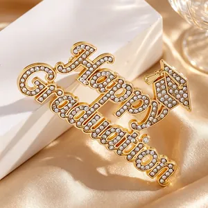 Macro view of a luxury gold rhinestoned Happy Graduation brooch for student gifts
