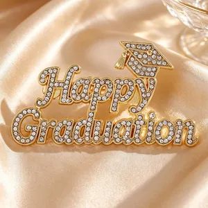 Close-up of a luxurious Happy Graduation brooch with rhinestones on satin fabric