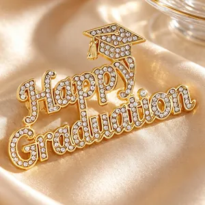 Close-up detail of gold crystal Happy Graduation brooch with elegant graduation cap design