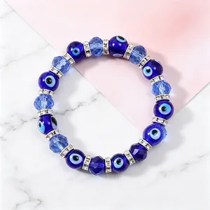 Close-up detail of blue Evil Eye beads and faceted crystals on elastic bracelet