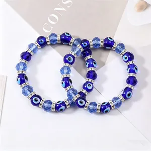 Detail showing blue evil eye crystal beaded bracelets with silver rhinestone spacers