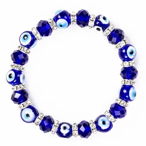 Macro view of blue Evil Eye glass beads and faceted crystals on an elastic bead bracelet