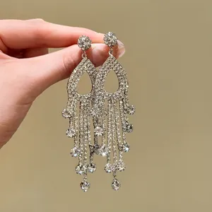 Detailed view of elegant sparkling rhinestone tassel earrings in silver-toned finish