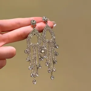 Close-up of sparkling silver tassel earrings with rhinestone crystals