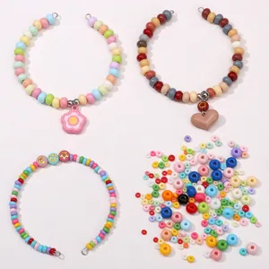 Detail of colorful glass seed beads set with heart and flower pendants for DIY jewelry