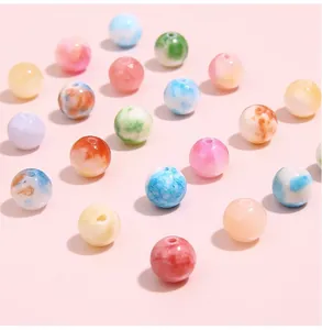 Macro shot of colorful marble pattern round beads with center holes for DIY jewelry