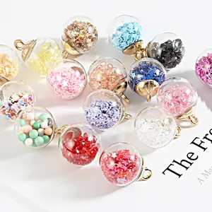 Macro shot of colorful glass ball charms with glitter star sequins for DIY jewelry making