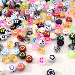 Flat lay of colorful acrylic moon and star charms for DIY bracelet and jewelry making
