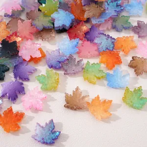 Macro view of colorful glitter maple leaf beads for handmade jewelry DIY projects