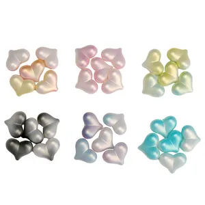 Macro view of gradient heart-shaped resin beads with pearlescent finish for DIY crafts