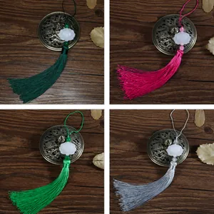 Macro detail of Chinese style tassels with carved lotus flowers in four classic colors
