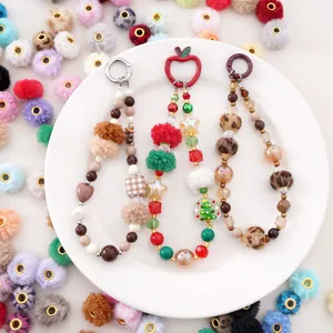 Colorful handmade beaded phone charms with soft plush balls and decorative star pendants