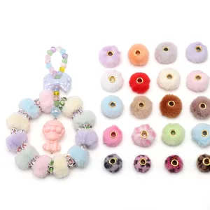 Macro shot of colorful faux mink fur balls and rhinestone beads for DIY crafts