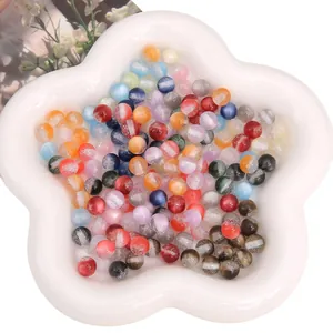 Mix of 8mm colorful resin beads with glitter sand effect and cat eye texture in a white bowl