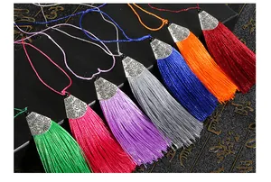 Macro shot of seven colorful silk tassels with vintage silver patterned metal caps
