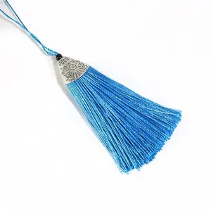 Bright blue handmade silk tassel with silver metal cap and woven rope for DIY crafts