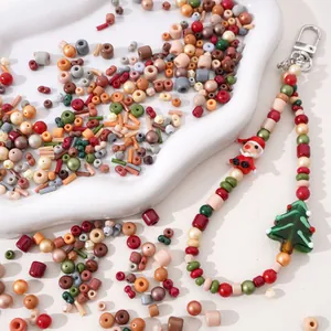 DIY Christmas themed glass beads set with Santa and tree charms in a white ceramic tray