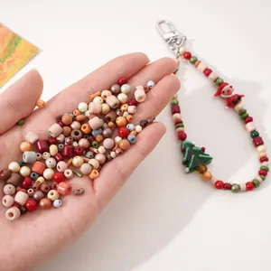 Christmas DIY bead kit with red, green, and gold beads plus Santa and tree pendants