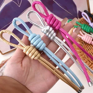 Macro shot of colorful handmade leather knot keychains with metallic end caps