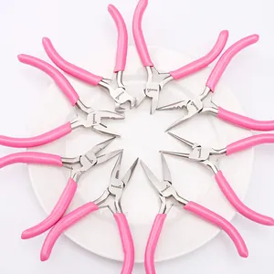 Pink jewelry pliers set with ergonomic handles arranged on a white ceramic plate for DIY crafts