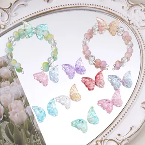 Detailed view of translucent glass butterfly beads and finished handmade charm bracelets
