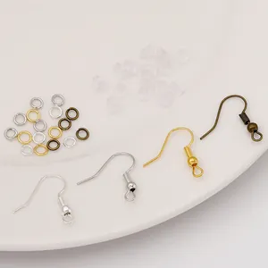 Macro view of DIY earring making kit with metal hooks, jump rings and silicone backs
