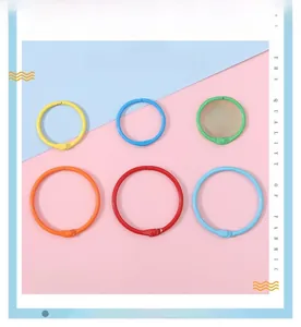 Close-up of colorful round metal keyrings in red, yellow, blue, and green for DIY crafts