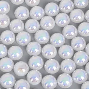 Close-up of iridescent white half-round ABS faux pearls with rainbow shine for DIY crafts