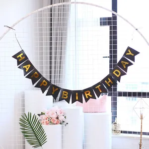 Detail of Happy Birthday black swallowtail paper banner with golden foil lettering