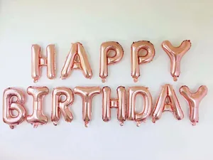 Close-up of rose gold foil balloons spelling HAPPY BIRTHDAY with metallic shine