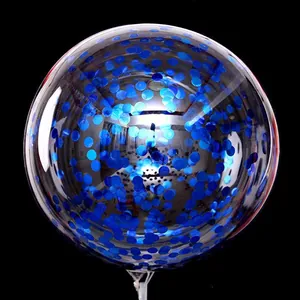 Macro detail of transparent party balloon filled with sparkling blue round sequins