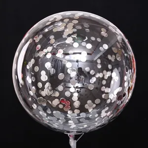 Macro detail of clear balloon filled with shimmering silver and red metallic sequins