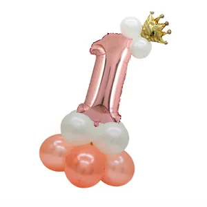 Detail of rose gold number 1 balloon with crown on white and pink latex stand