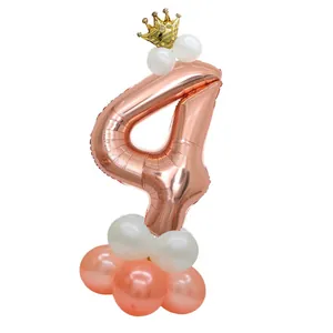 Detail of rose gold number 4 balloon with gold crown and pink latex base decor