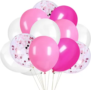 Detail of pink and white latex balloons set with colorful confetti and beige hanging ribbons