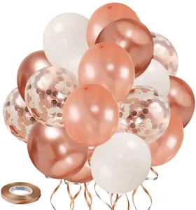 Detail of rose gold and white balloons set with confetti and curling ribbon for parties