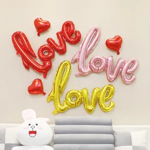 Red pink and gold LOVE script foil balloons with heart accents for wedding party decor