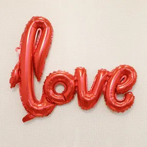 Detail of red metallic LOVE foil balloon with vibrant glossy texture for party decor