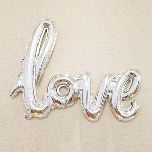 Silver foil LOVE letter balloon for wedding party decor on beige striped background