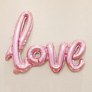 Detailed view of pink metallic LOVE foil balloon for wedding and party decorations