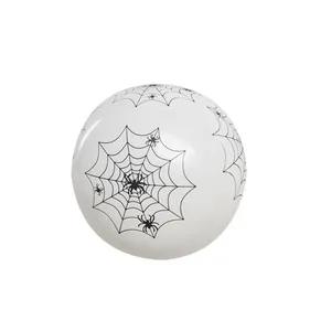 Detailed view of white latex Halloween balloon with black spider web and spider prints