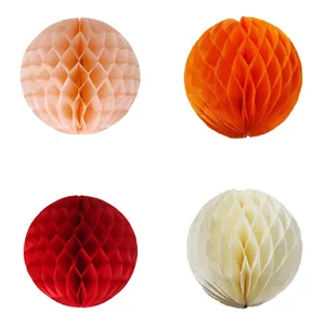 Detail of paper honeycomb balls in pink, orange, red and white for wedding party decor