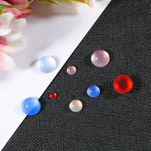 Close-up of colorful resin cat-eye gems in various sizes for DIY jewelry crafting