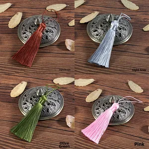 Detail of 8cm decorative tassels in light coffee, light grey, olive green, and pink