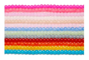 Flat lay macro of 12 colorful round glass beads for handmade jewelry DIY projects