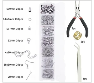 Macro shot of silver jewelry making set with pliers tweezers and lobster clasps