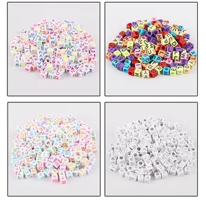 Macro detail of acrylic cube alphabet beads for DIY jewelry making in four color styles