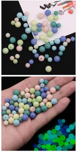Frosted luminous glass beads in macaron colors with blue and green glow for DIY jewelry