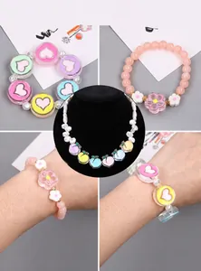 Detail of colorful acrylic heart bracelets and peach pendant necklace for DIY jewelry